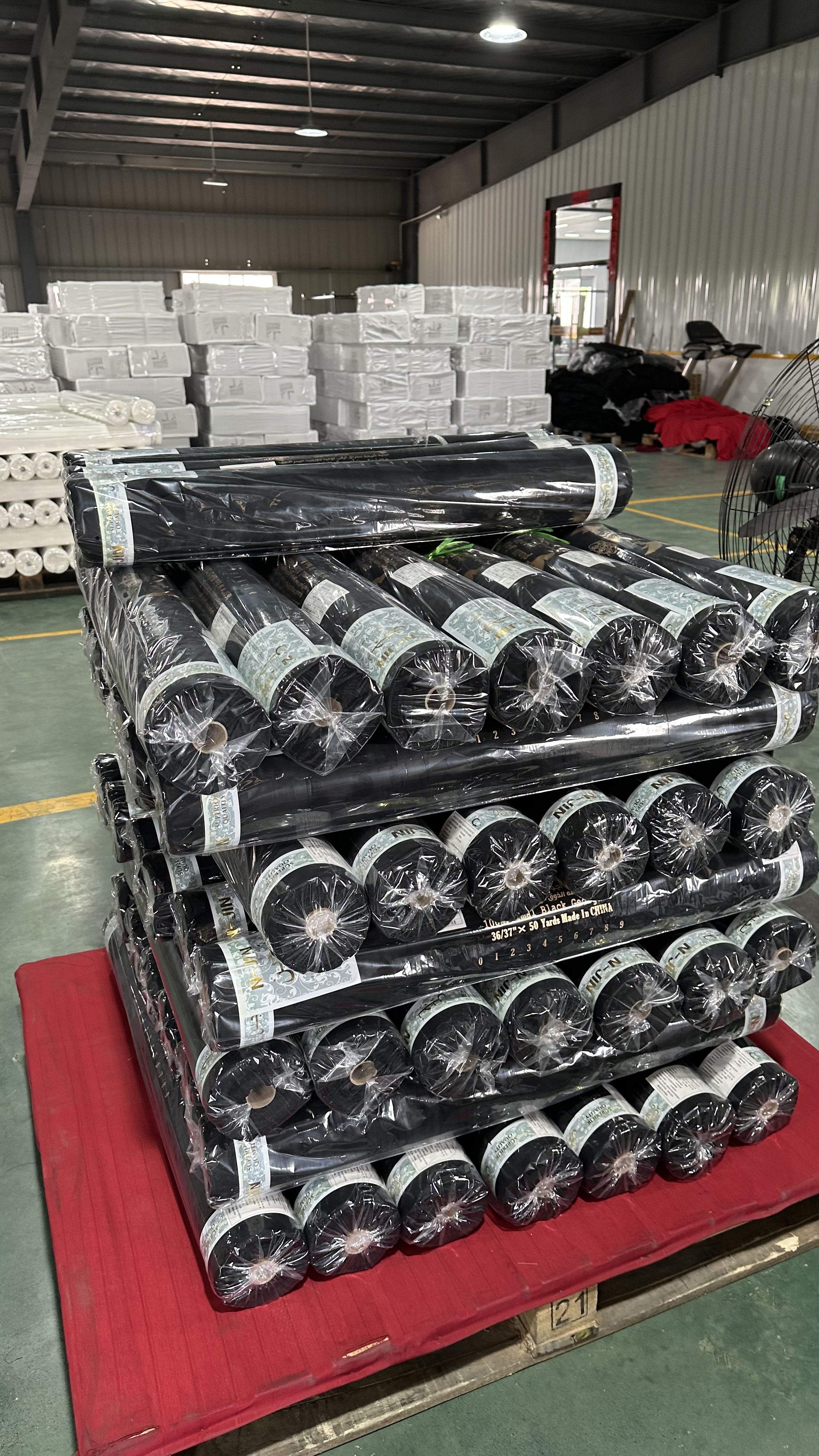 Finished fabric rolls prepared for storage and delivery